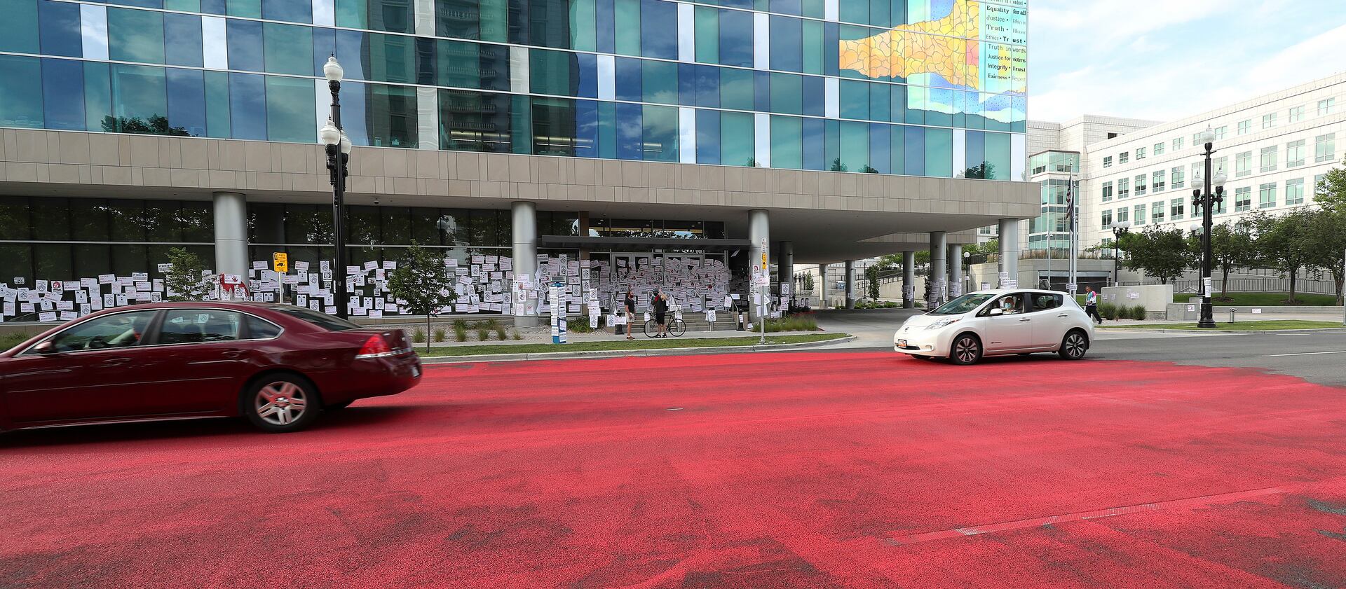 Family and friends of Bernardo Palacios-Carbajal painted the street red in protest in front of the Salt Lake County District Attorney’s Office in Salt Lake City.