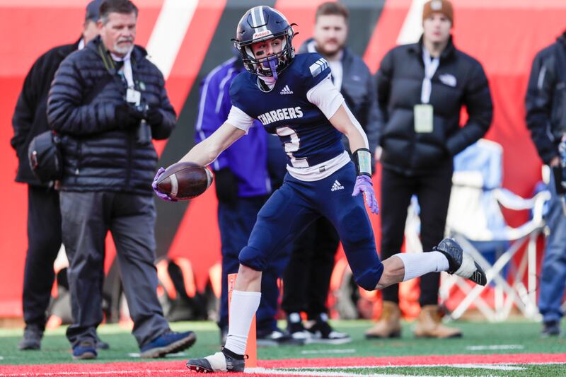 Corner Canyon Chargers’ Tate Kjar (wearing purple) runs the ball for a touchdown