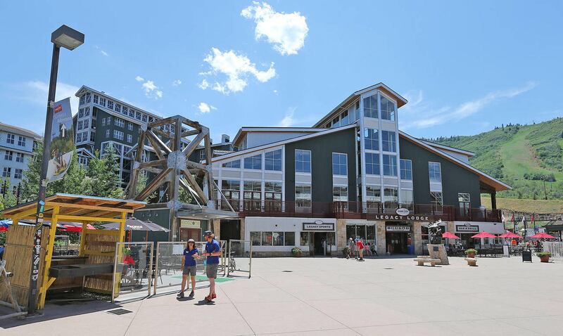 Workers talk at the base of the Park City Mountain Resort, Wednesday, July 2, 2014, in Park City. A hearing to rule on a bond for Park City Mountain Resort has been postponed until Friday, Sept. 5.