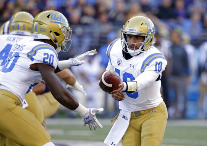 UCLA quarterback Devon Modster hands-off against Washington in the second half of an NCAA college football game Saturday, Oct. 28, 2017, in Seattle. Washington won 44-23.