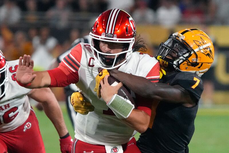 Arizona State defensive back Timarcus Davis (7) tackles Utah quarterback Cam Rising during game Saturday, Sept. 24, 2022, in Tempe, Ariz.