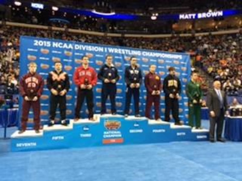 Penn State's Matt Brown stands atop the podium after winning the 174-pound NCAA national title. Brown is a native of West Valley City and is a graduate of Cyprus High School.