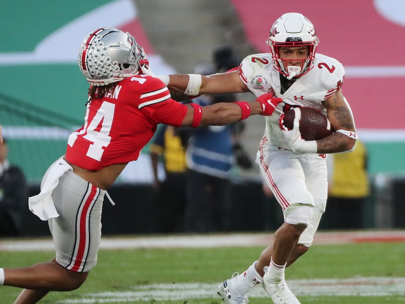 Utah’s Micah Bernard runs against Ohio State safety Ronnie Hickman during the Rose Bowl in Pasadena, Calif., on Jan. 1, 2022.