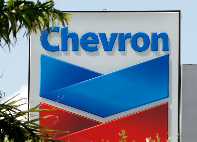 FILE- This Aug. 20, 2012, file photo, shows a Chevron sign in Miami. A Northern California jury ordered Chevron Corp. to pay the families of two brothers a combined $21.4 million after they claimed the men's exposure to a toxic chemical while working at a