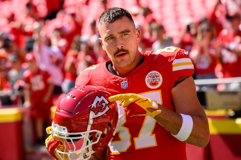 Kansas City Chiefs tight end Travis Kelce points to the Chiefs decal on his helmet before a game on Sept. 24, 2023.
