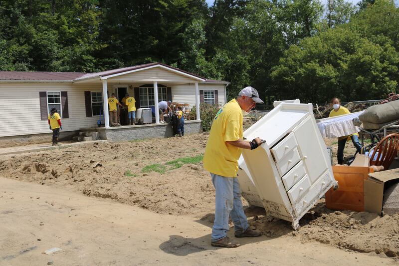 Members of the Crestwood Kentucky Latter-day Saint Stake help remove furniture and debris from a home in Whitesburg, Kentucky.