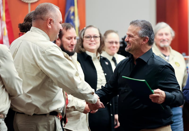 Al Palmer, Salt Lake County Veterans Treatment Court mentor coordinator, shakes hands with Navy veteran Carl Costello during a Veteran’s Court graduation ceremony at the Matheson Courthouse in Salt Lake City on Thursday.