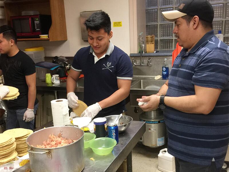 Men prepare food for a Mexican Taqueria sponsored by Pilgrim-St. Luke\'s and El Nuevo Camino United Church of Christ in Buffalo, N.Y., in November 2016.