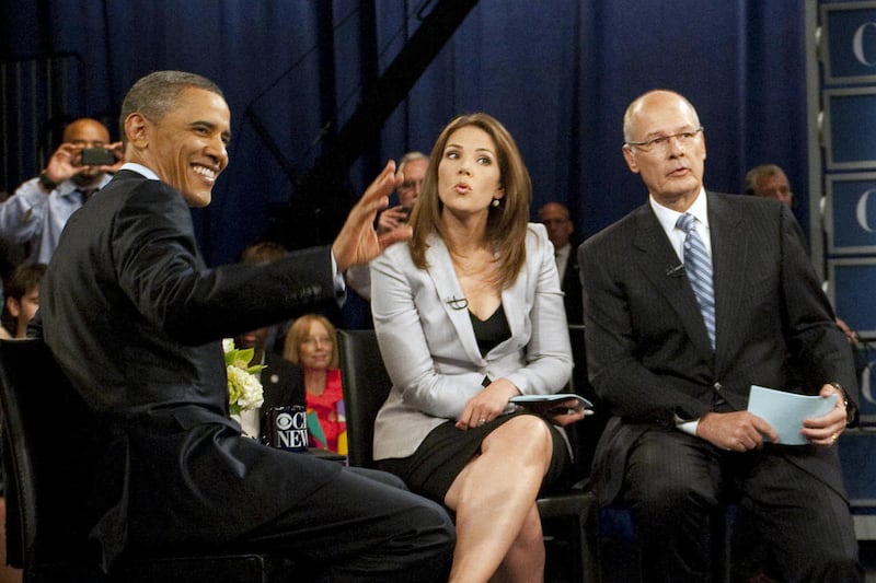 This photo released and Sunday, May 15, 2011, by CBS News' "Face the Nation" shows President Barack Obama greeting audience members with hosts Harry Smith, right, and Erica Hill as he answers questions about the economy during a town hall meeting pre-tape