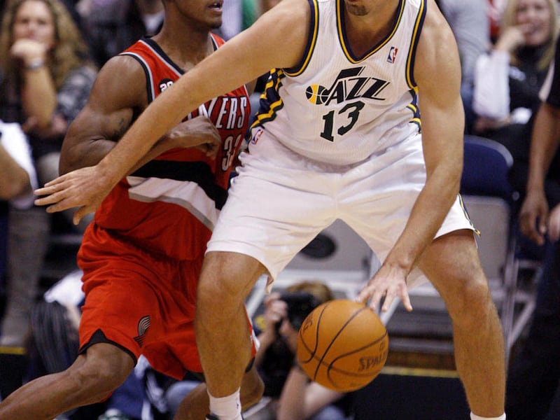 Utah Jazz forward Mehmet Okur (13), of Turkey, drives along the baseline against Portland Trail Blazers forward Dante Cunningham, left, during the first half of their NBA basketball game in Salt Lake City, Monday, Dec. 27, 2010.