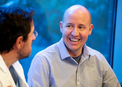 Heart transplant recipient Ben Burrup, right, speaks with Dr. Craig Selzman, chief of the Division of Cardiothoracic Surgery at the University of Utah, during a press conference at the University of Utah Hospital in Salt Lake City on Friday, Jan. 4, 2019.
