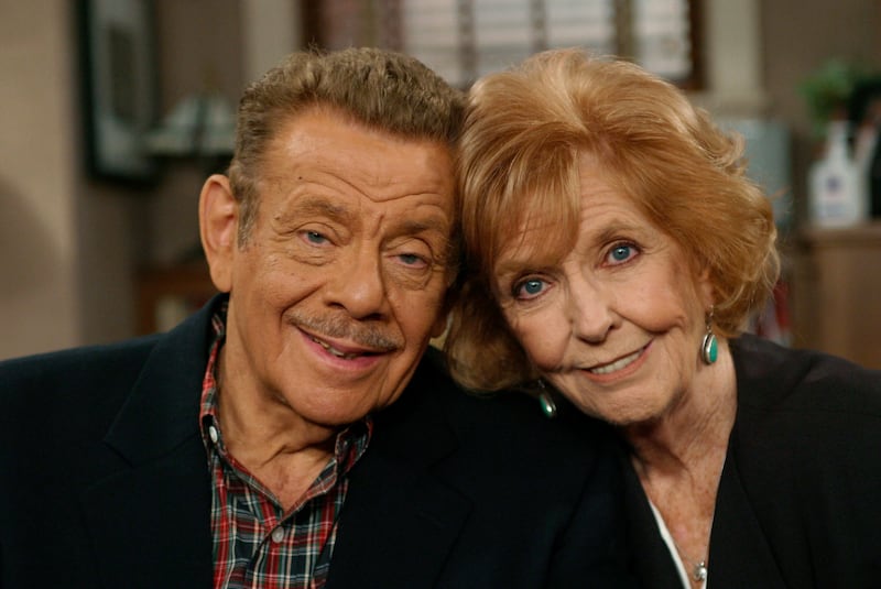 FILE- In this Nov. 6, 2003, file photo, Jerry Stiller, left, and his wife Anne Meara pose on the set of “The King of Queens,” at Sony Studio in Culver City, Calif. Stiller, a comedy veteran who launched his career opposite wife Meara in the 1950s and reemerged four decades later as the hysterically high-strung Frank Costanza on the smash television show “Seinfeld,” died of natural causes at the age of 92, his son Ben Stiller announced Monday, May 11, 2020. (AP Photo/Stefano Paltera, File)