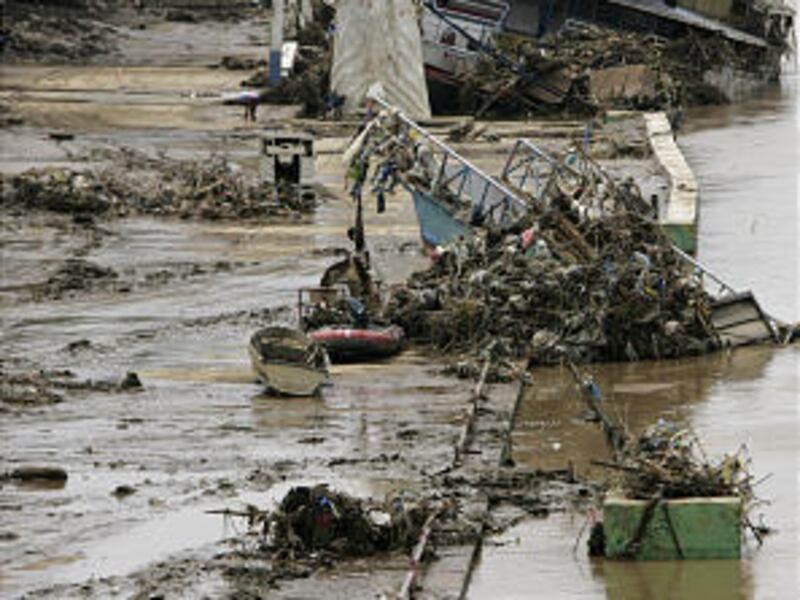 A man walks among debris from Typhoon Ketsana, which hit the Philippines on Sept. 26, in Marikina town Sunday. On Saturday, at least 16 people died when Typhoon Parma hit the main island of Luzon, though Manila — still recovering from Kestana — was spared