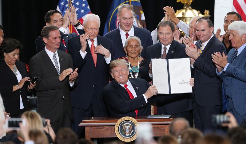FILE - President Donald Trump signs proclamations to scale back Bears Ears and Grand Staircase Escalante National Monuments at the State Capitol in Salt Lake City on Monday, Dec. 4, 2017.