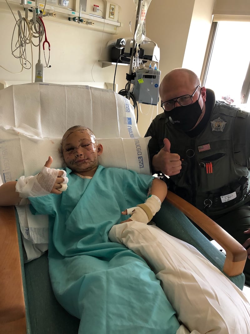 Lily A. Kryzhanivskyy, 9, in the hospital with Sgt. Tony Leonetti.