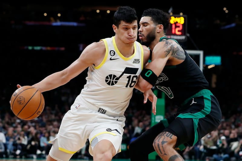 Utah Jazz’s Simone Fontecchio (16) drives against Boston Celtics’ Jayson Tatum (0) during the first half of an NBA basketball game Friday, March 31, 2023, in Boston. (AP Photo/Michael Dwyer)
