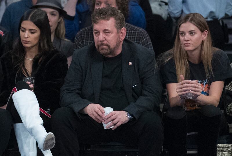 FILE - In this Oct. 20, 2018, file photo, Madison Square Garden chairman James Dolan, center, watches an NBA basketball game between the New York Knicks and the Boston Celtics at Madison Square Garden in New York. The Knicks recently drew a $50,000 fine f