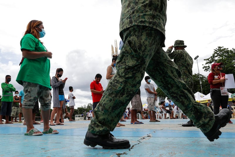 Policemen talk to residents in Quezon city, Philippines.