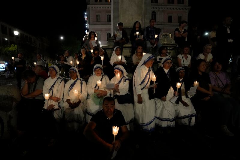 Faithful gather in front of the Vatican’s Basilica of St. Mary Mayor in Rome, Oct. 15, 2023, to lead a prayer for peace.