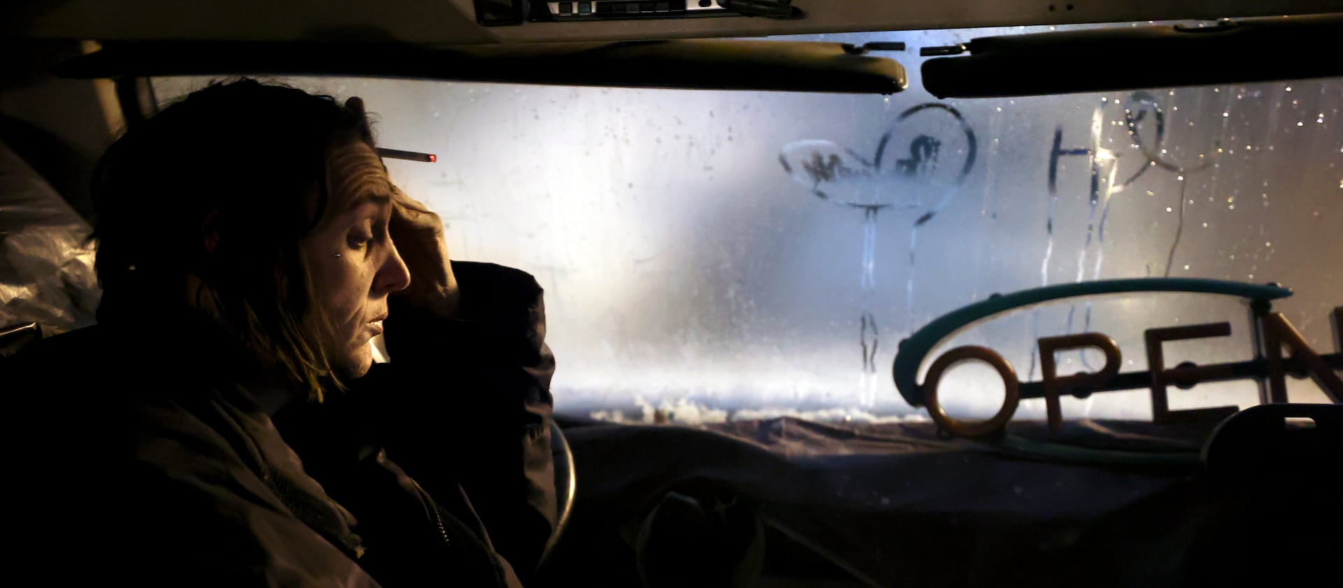 Barbara Elmer, who is unsheltered, is sick while sitting on the Nomad Alliance bus in Salt Lake City, on March 8, 2023.