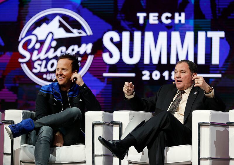 Qualtrics CEO Ryan Smith, left, and Gov. Gary Herbert participate in a panel discussion during the Silicon Slopes Tech Summit in Salt Lake City on Friday, Jan. 19, 2018.