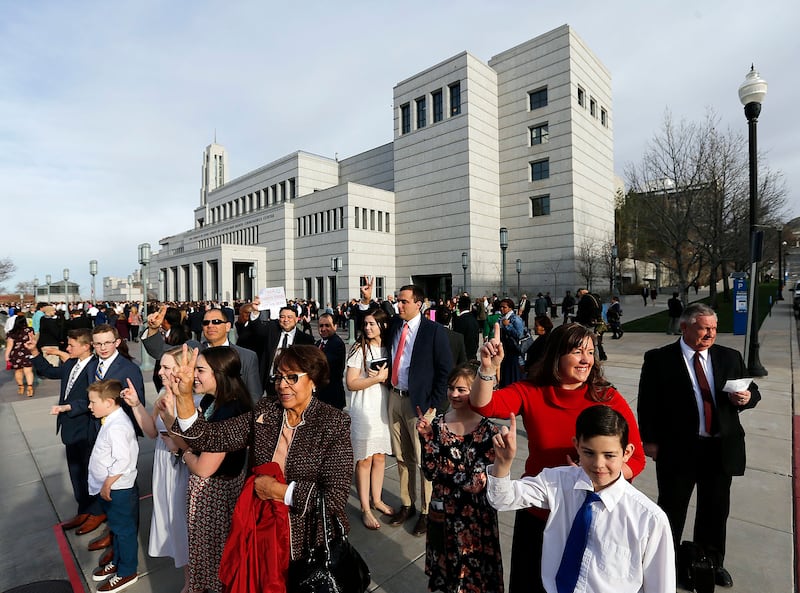 Conferencegoers hold up their hands in search of tickets before the Saturday morning session of the 188th Annual General Conference of The Church of Jesus Christ of Latter-day Saints in Salt Lake City on Saturday, March 31, 2018.