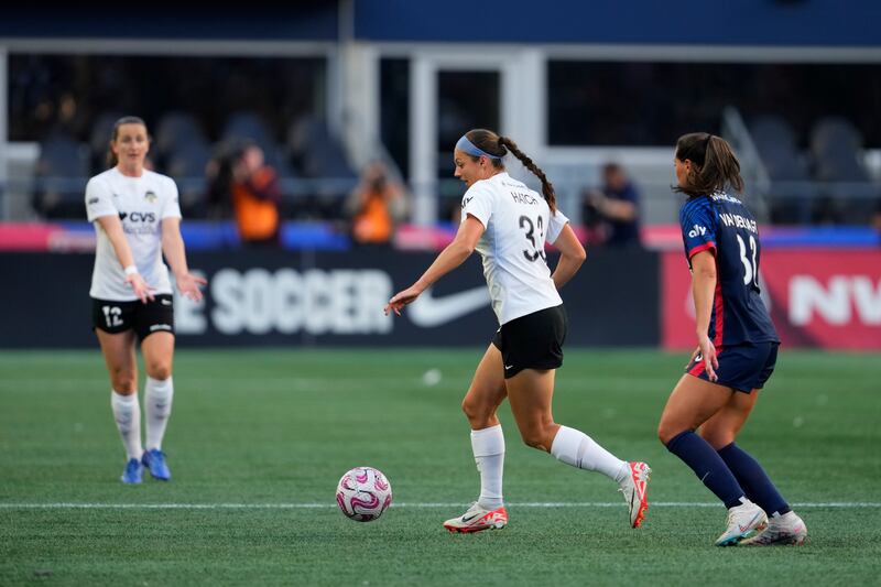 Washington Spirit forward Ashley Hatch moves the ball against OL Reign midfielder Olivia Van der Jagt, Friday, Oct. 6, 2023, in Seattle.