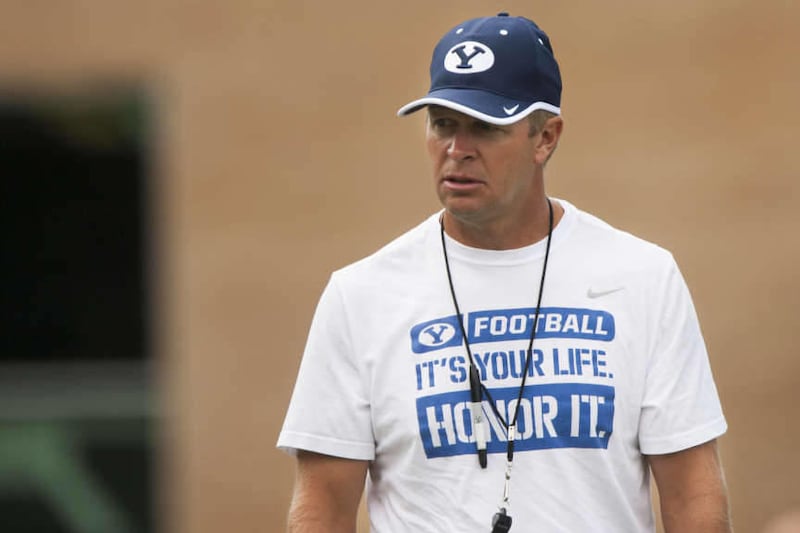 Head Coach Bronco Mendenhall coaches during a BYU football practice at BYU's practice fields, Thursday, Aug. 14, 2014.