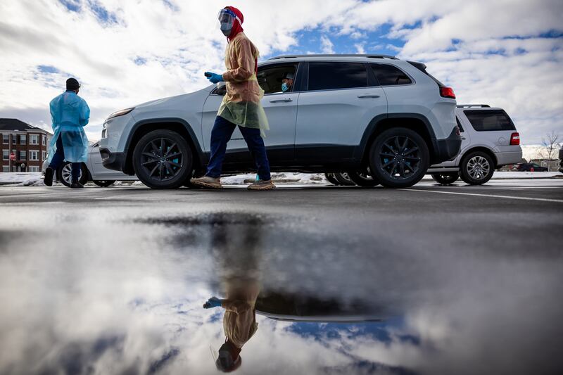 Health care worker Bob Ekoh administers COVID-19 tests at City Hall in Herriman.