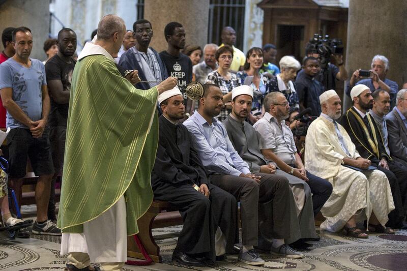 Muslims attend a Mass in Rome's Saint Mary in Trastevere church, Italy, Sunday, July 31, 2016. Imams and practicing Muslims attended Mass across Italy, from Palermo in the south to Milan in the north, in a sign of solidarity after the France church attack