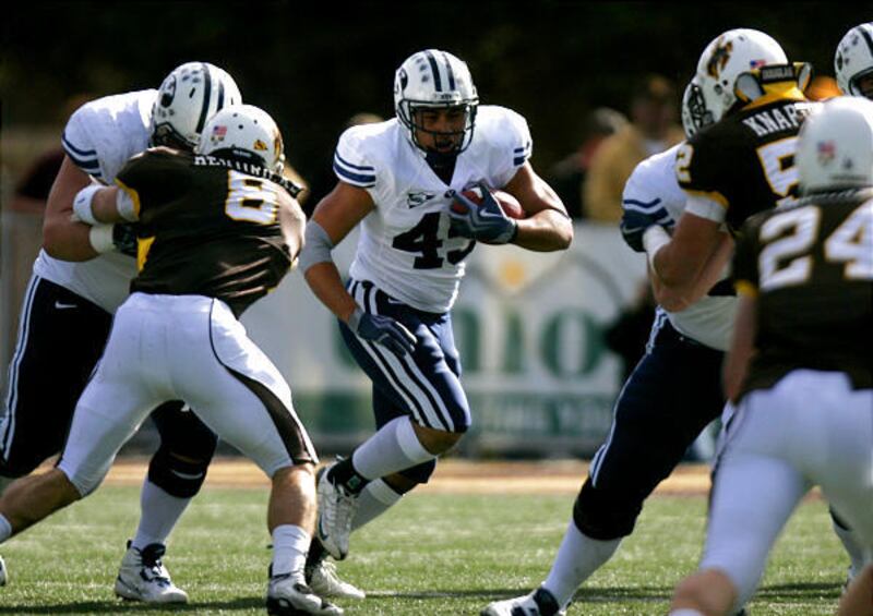 Brigham Young running back Harvey Unga (45) looks for ways to dodge Wyoming's defense during the first half of a NCAA college football game of BUY Cougars vs. Wyoming Cowboys at War Memorial Stadium in Laramie, Wyo., Saturday, Nov. 7, 2009. Chen Wang, Des