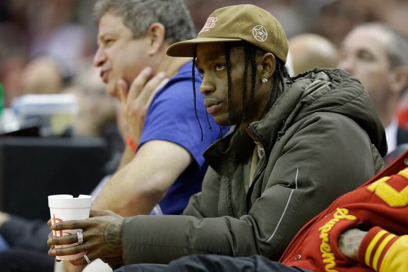 Rapper Travis Scott watches an NBA basketball game between the Houston Rockets and the Philadelphia 76ers, Friday, Jan. 3, 2020, in Houston.