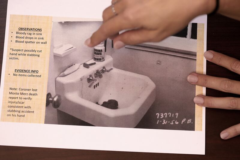 Los Angeles police detective Rachel Evans points on June 2, to the evidence photo of a bloody towel left in the sink of a murder scene while lamenting the fact that the towel itself was not booked into evidence. Evans recently solved the oldest cold case murder in the valley by determining that Monte Merz killed Barbara Jepson and her unborn child in 1956 in a brutal stabbing in her home.