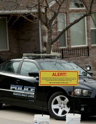 A warning sign and a police officer's vehicle are stationed at Walt Gilmore's home on Thursday, March 21, 2019.