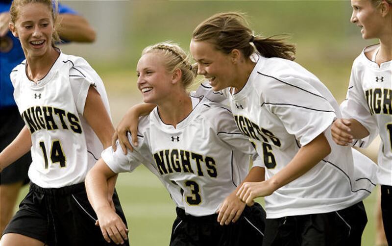 Lone Peak's Maris Hamblin, second from left, is praised by McKenna Jared and Hannah Morris after winning goal.