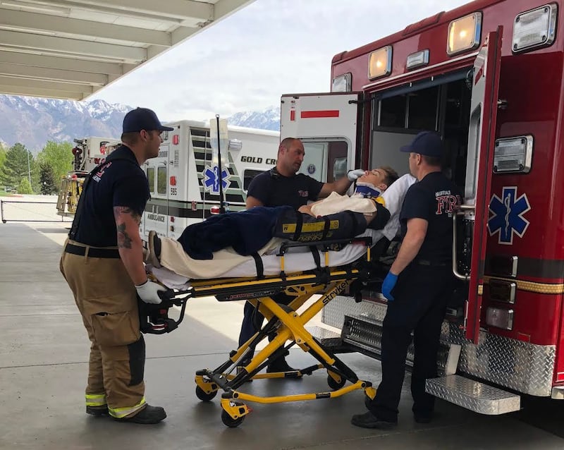 Summit Academy shortstop Kolby Hamblin is loaded into an ambulance after being hit by a car at the Bluffdale school.