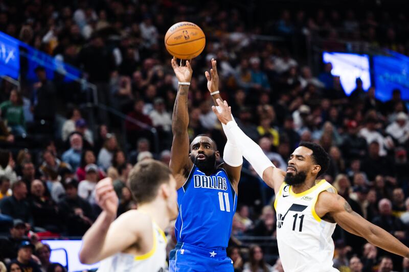 Dallas Mavericks guard Tim Hardaway Jr. (11) shoots the ball as Utah Jazz guard Mike Conley (11) closes in during an NBA game at Vivint Arena in Salt Lake City on Monday, Feb. 6, 2023.