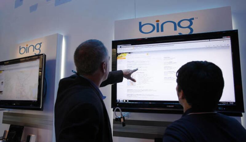 In this Jan. 7, 2010, photo, attendees look at the Bing display at the Microsoft exhibit at the Consumer Electronics Show in Las Vegas.