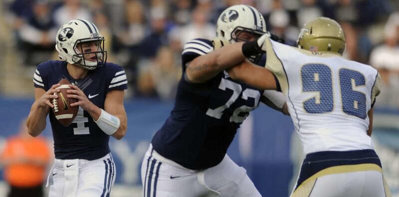 Brigham Young Cougars quarterback Taysom Hill (4) looks for a receiver as Brigham Young Cougars offensive linesman Ryker Mathews (72) block Georgia Tech Yellow Jackets defensive lineman Adam Gotsis (96) during a game at LaVell Edwards Stadium on Saturday,