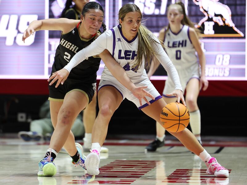 Highland’s Sosefina Langi , wearing black, tries to knock the ball away from Lehi’s Jamisyn Heaton , wearing whiteduring a 5A semifinal game