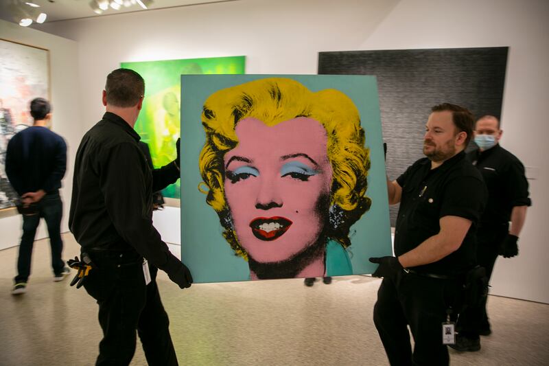 The 1964 painting Shot Sage Blue Marilyn by Andy Warhol is visible in Christie’s showroom in New York City.