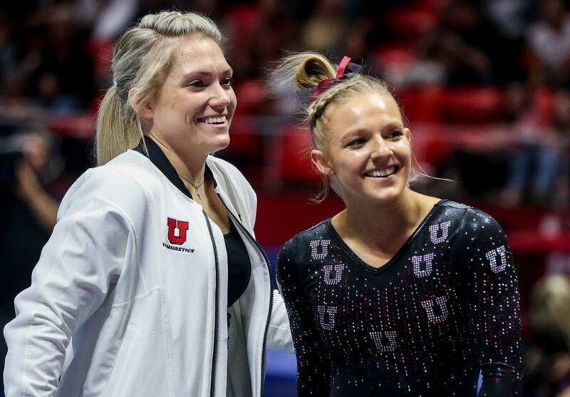 Former Utah assistant coach Courtney McCool Griffeth and gymnast Jillian Hoffman smile after Hoffman’s floor peformance.