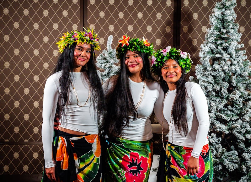 Three dancers pose for a photo at the first-ever Light the World dinner hosted by The Church of Jesus Christ of Latter-day Saints in Geneva, Switzerland, where they performed a traditional dance from Samoa on Tuesday, Dec. 2, 2025.
