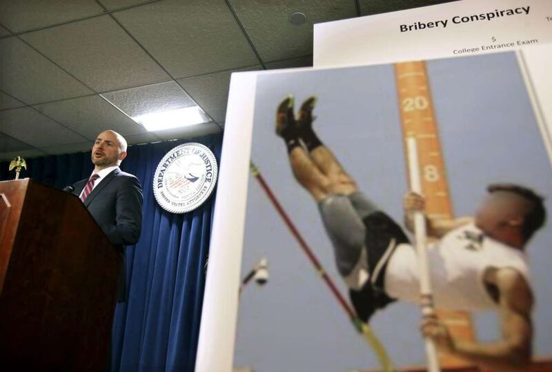 U.S. Attorney for District of Massachusetts Andrew Lelling announces indictments during a news conference March 12 in Boston. At right is a photograph that federal investigators say was doctored as part of an effort to guarantee a student's admission to c