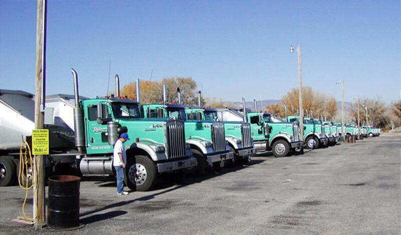 Truck driver Mike Christensen of Salina among a row of idled trucks belonging to Robinson Transport, also in Salina. The coal-hauling trucks and drivers are awaiting the reopening of the Sufco mine, where longwall mining activity has been shut down since