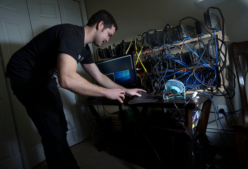 Jacob Berezay adjusts his Ethereum mining setup in South Salt Lake on Thursday, Dec. 28, 2017.