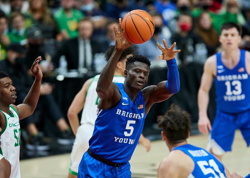 BYU forward Gideon George passes the ball.