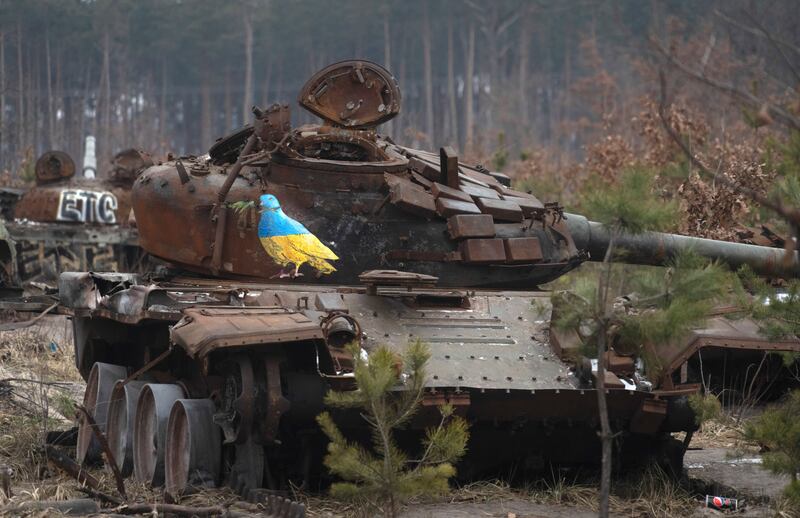 A destroyed Russian tank with an artwork depicting a dove with an olive branch by famous street artist TvBoy in the village of Dmytrivka, outside Kyiv, Ukraine.