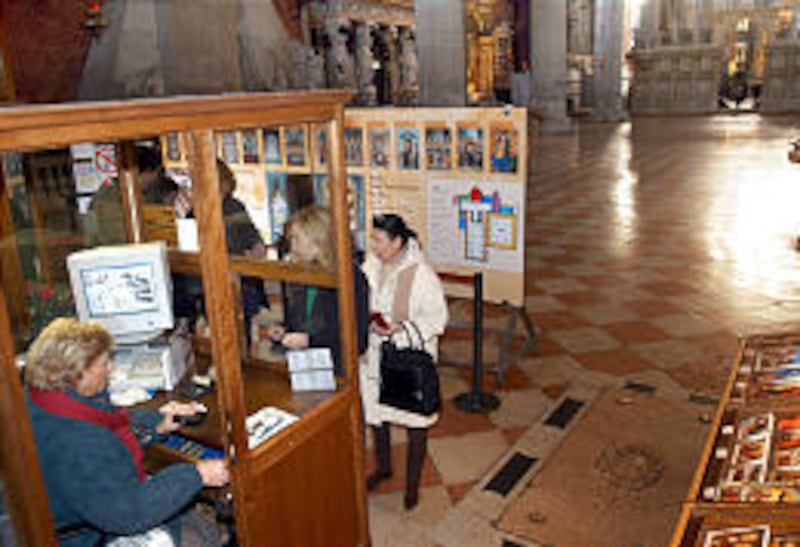 People line up to buy tickets inside Santa Maria Gloriosa dei Frari church, in Venice, Italy.