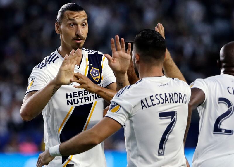 LA Galaxy midfielder Romain Alessandrini (7) celebrates his goal with teammate Zlatan Ibrahimovic during the first half of an MLS soccer match against Minnesota United, Saturday, Aug. 11, 2018, in Carson, Calif.